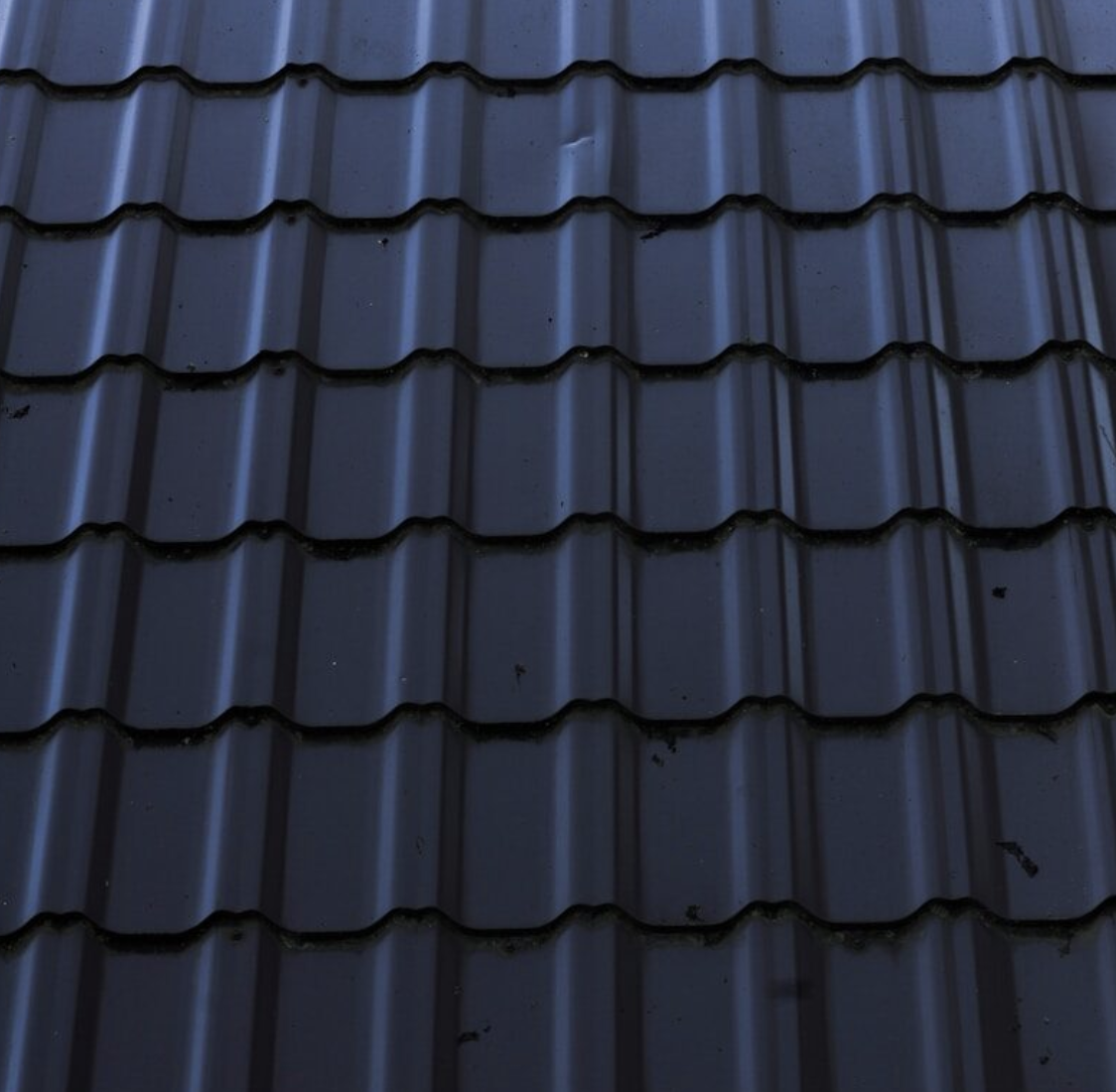 a close up of a metal roof with a sky background