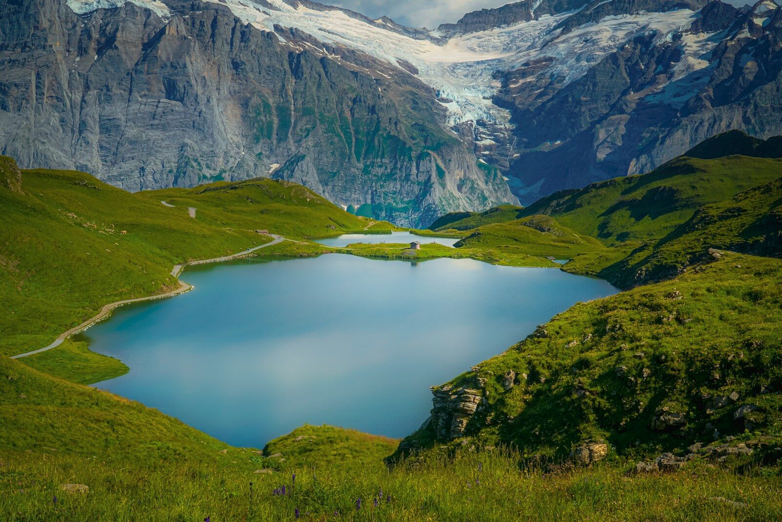 green and white mountains near lake during daytime